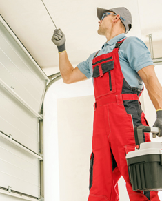 Fortify Services technician performing garage door repair spring adjustment, jammed door fix, garage door opener troubleshooting in Ontario