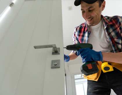 Professional locksmith repairing door lock in Ontario home