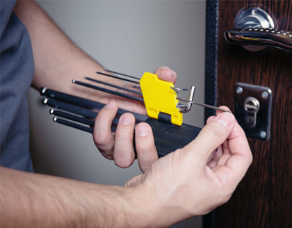 Locksmith repairing door lock with professional tools in Ontario
