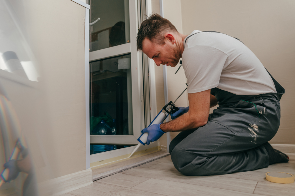 Basement window installation with caulking for seal
