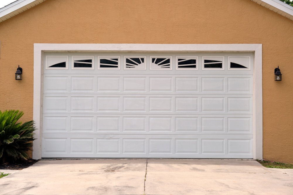 Modern white residential garage door on Canadian home exterior