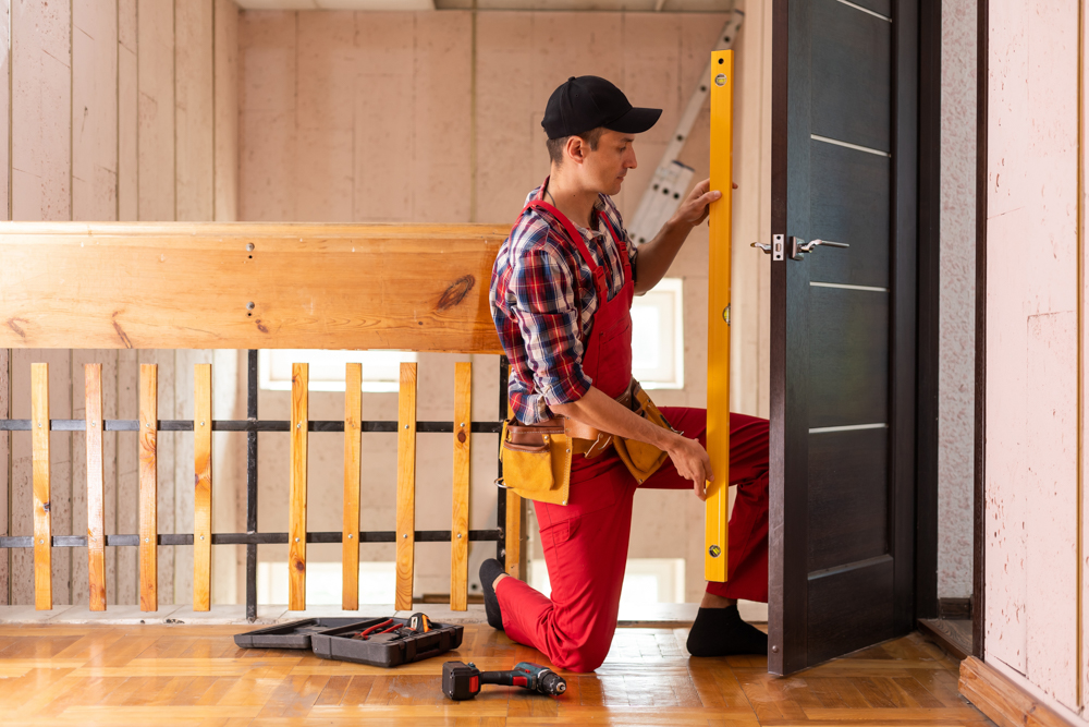 Professional door installation service in Toronto – technician using level for accurate fitting