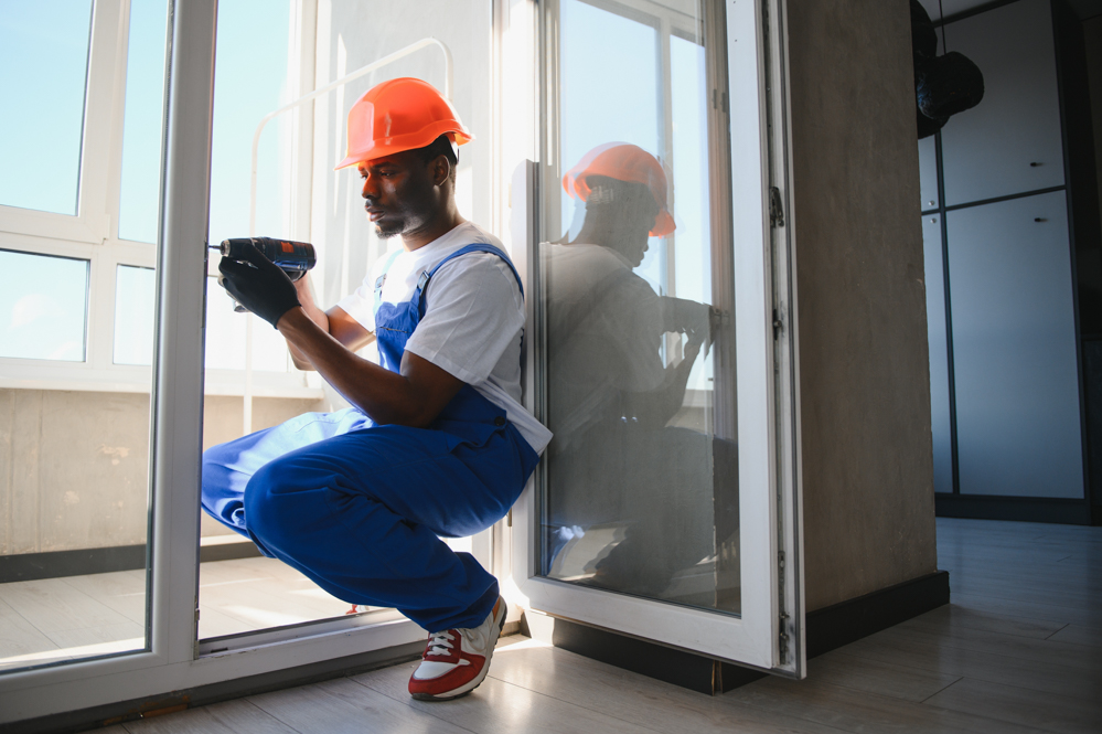 Technician installing glass doors in Canadian home