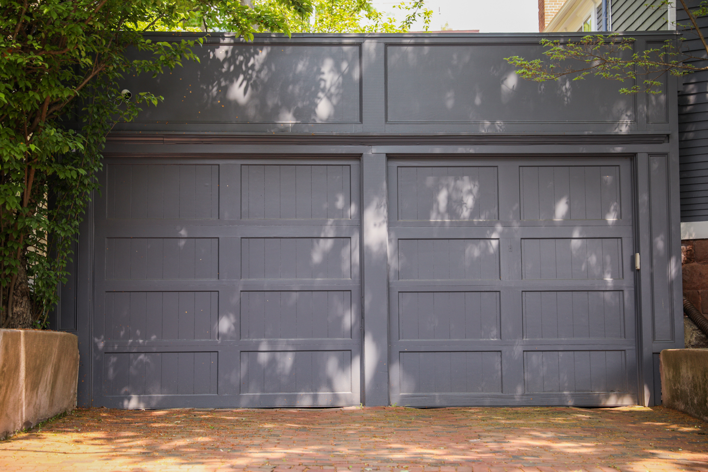 White residential garage door with windows in Canadian home driveway