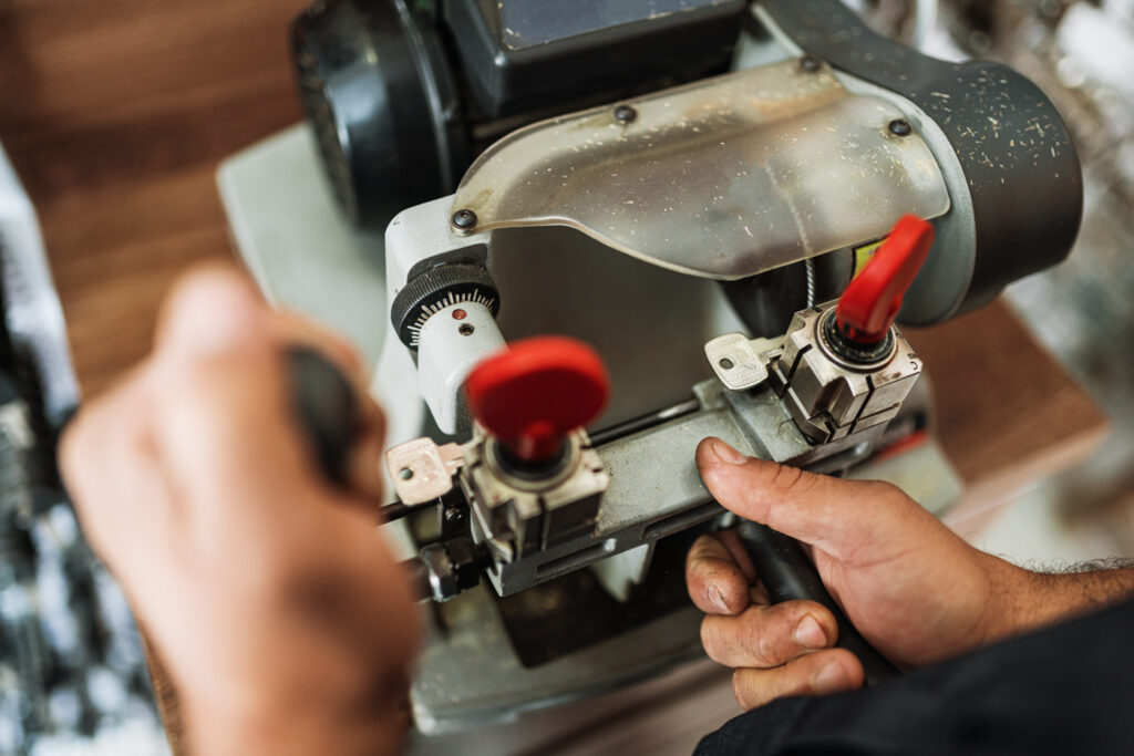 Key cutting for high security locks by locksmith technician