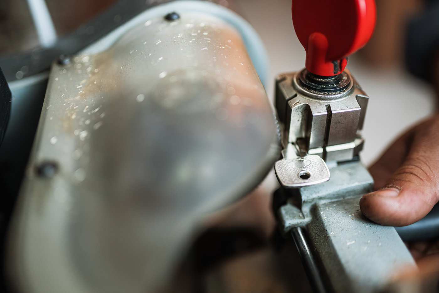 Key cutting for high security locks by locksmith technician