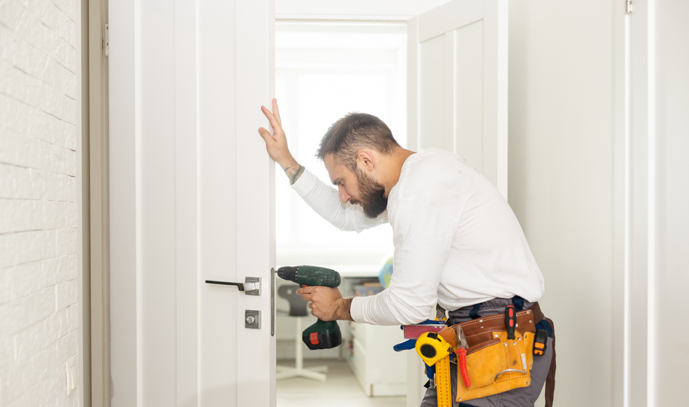 Locksmith unlocking residential door lock securely