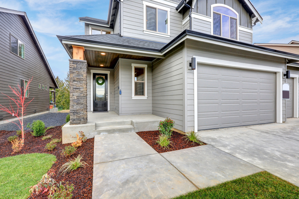 Modern glass garage door on Canadian home driveway