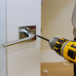 Locksmith installing anti-pick lock for home security