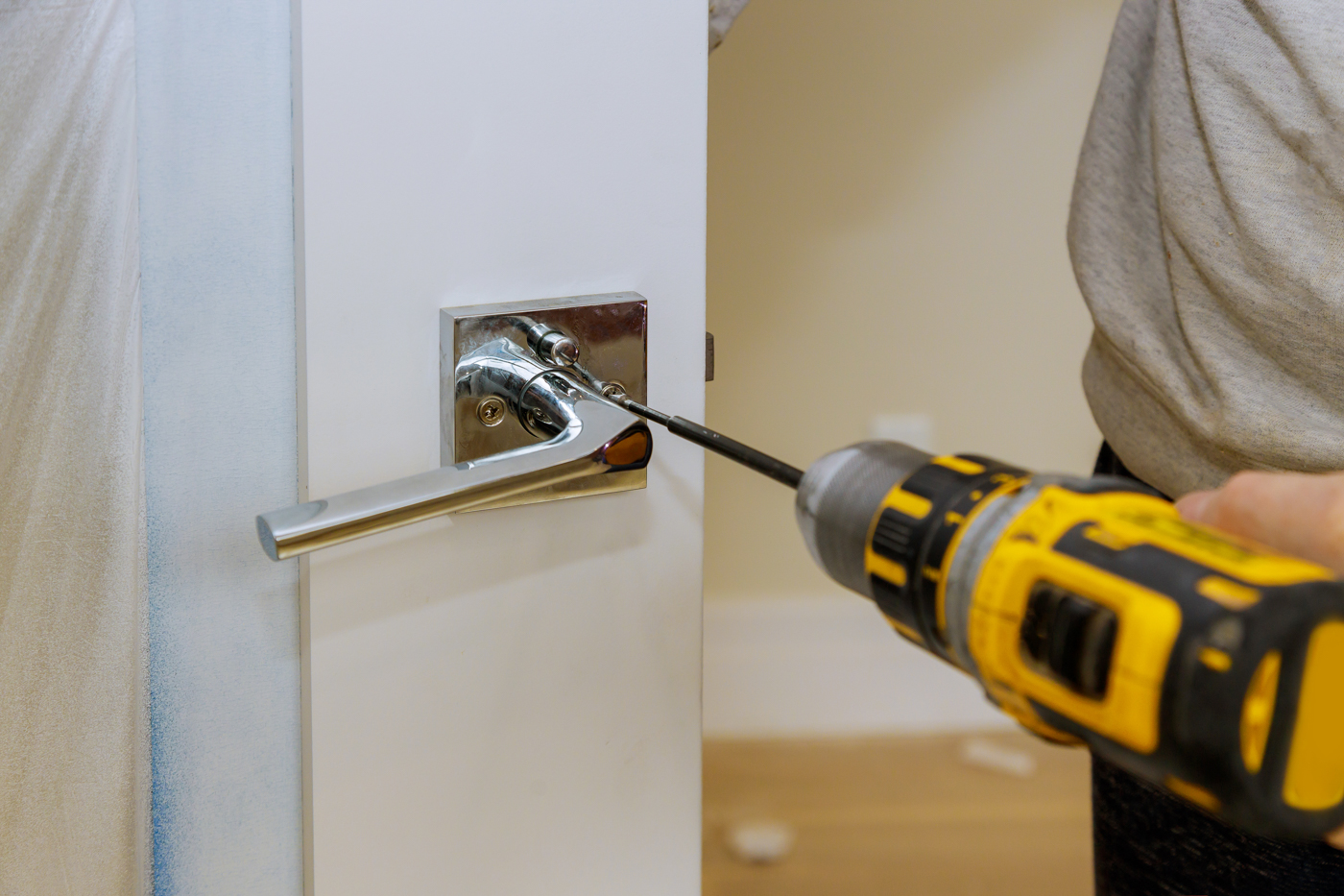 Locksmith installing anti-pick lock for home security