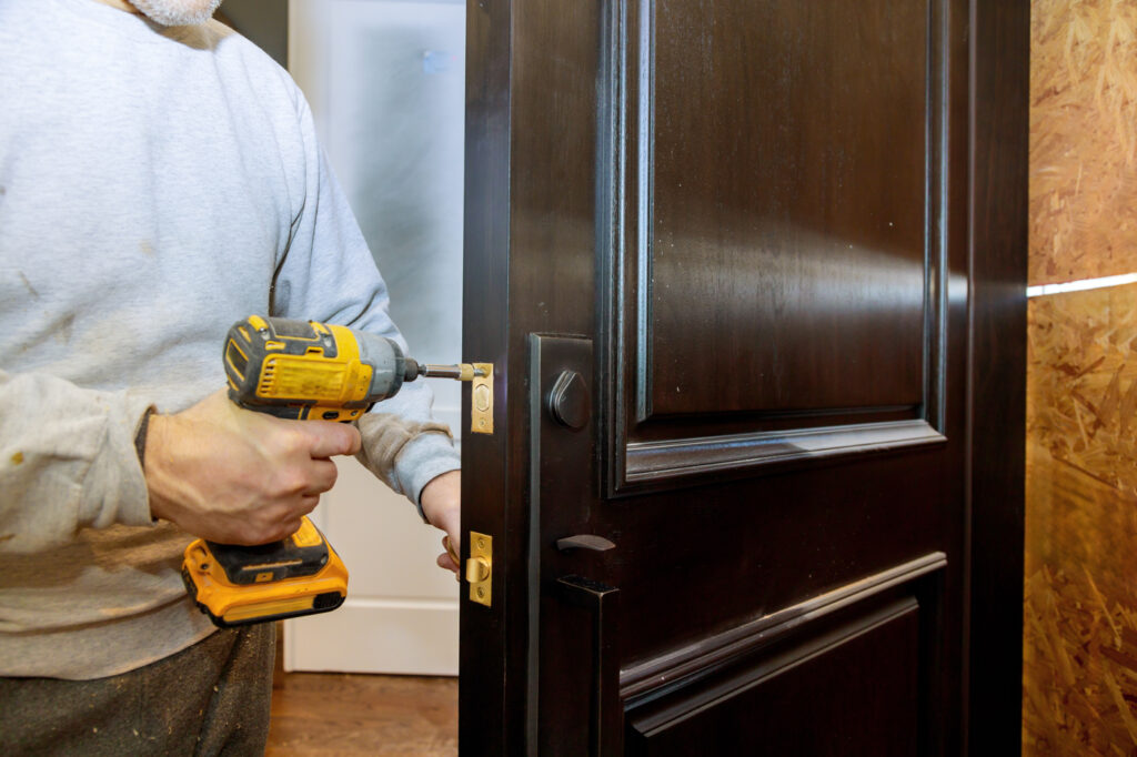 Lock installation on dark wood door for condo repair