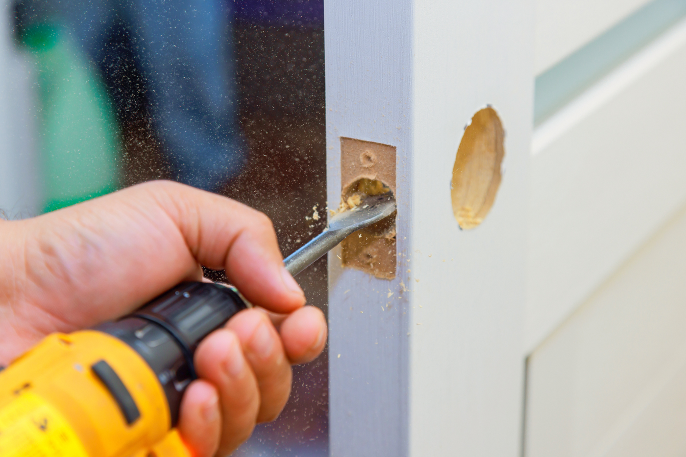 Lock installation on dark wood door for condo repair