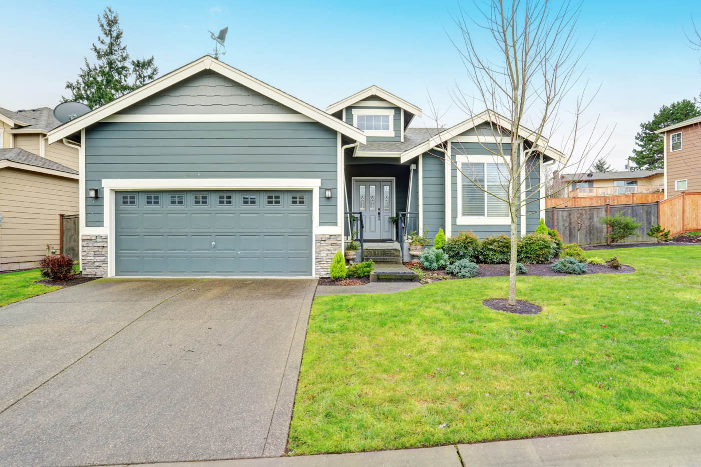 Traditional residential garage doors with window inserts