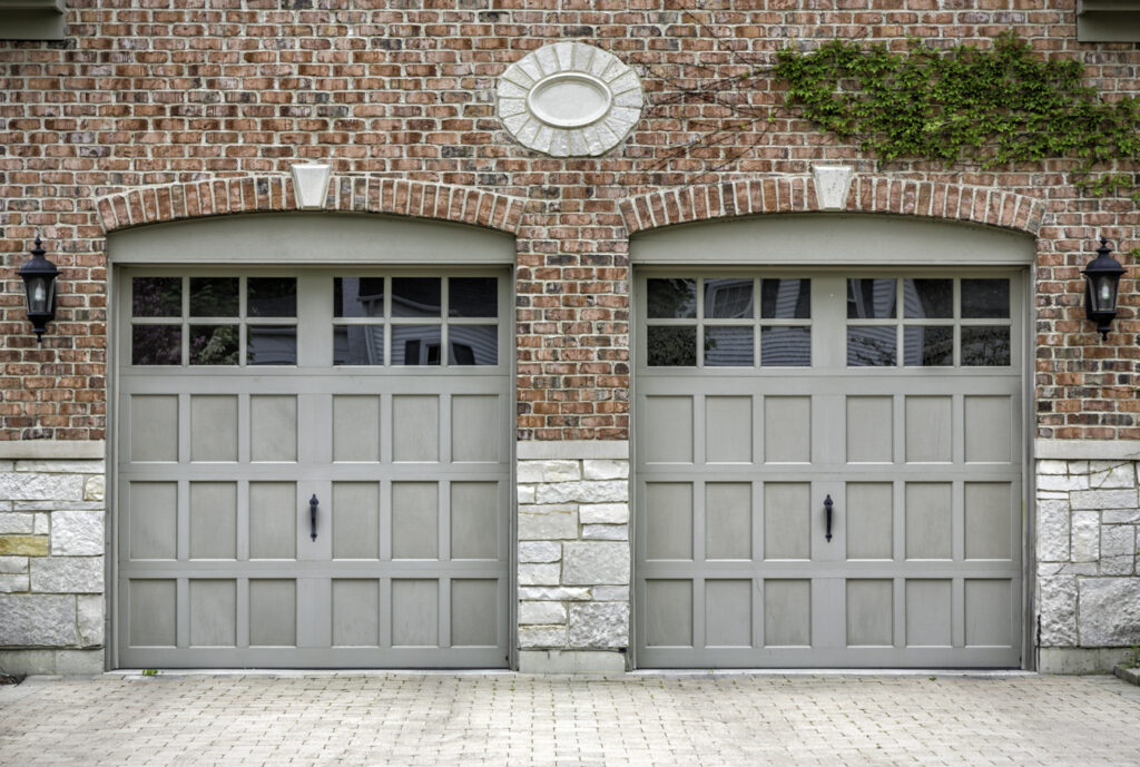 Traditional residential garage doors with window inserts