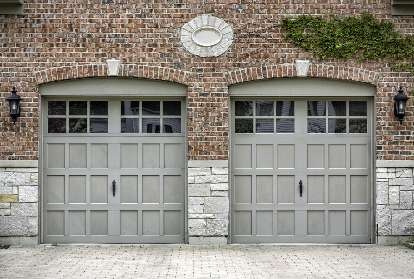Traditional residential garage doors with window inserts