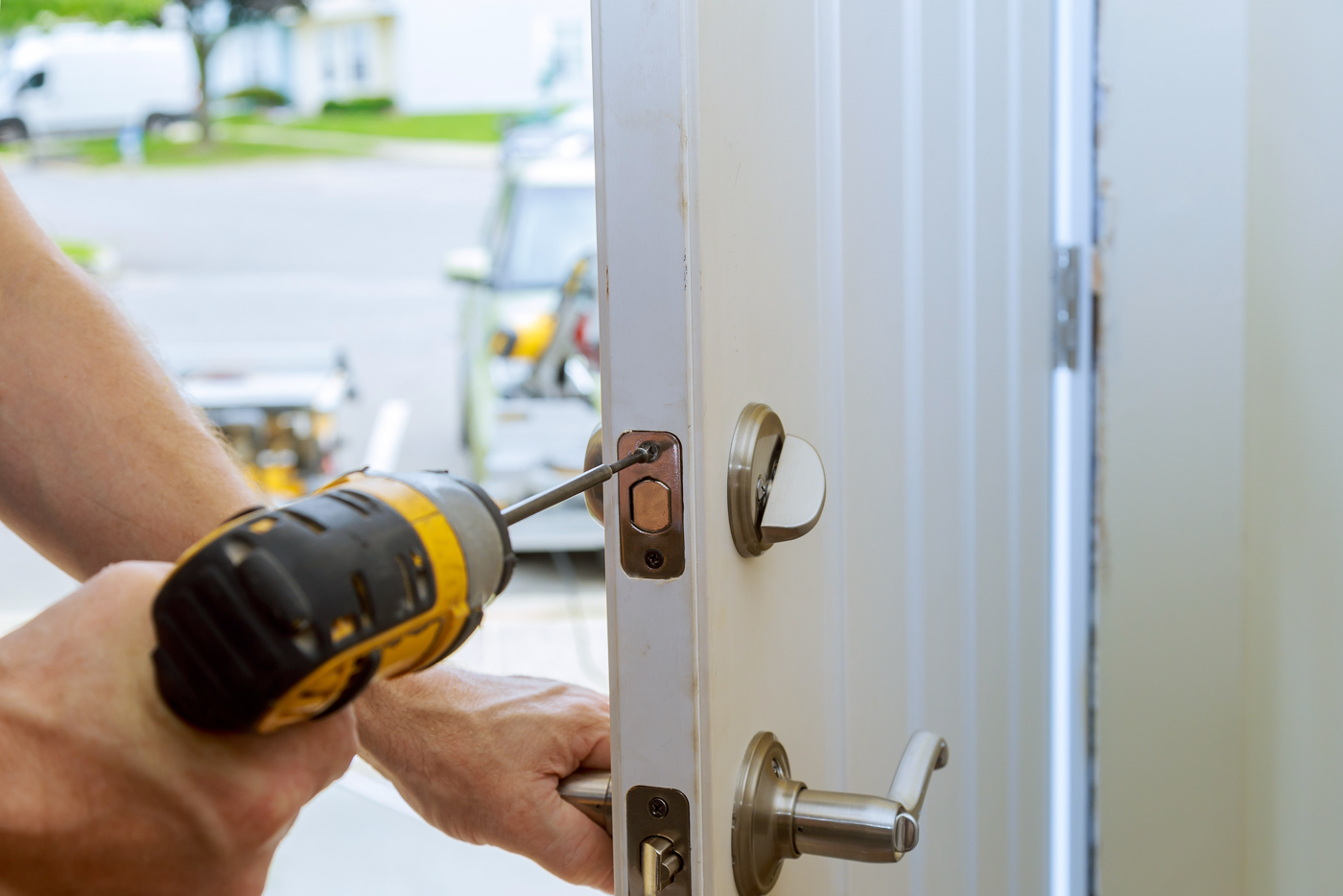 Locksmith installing deadbolt lock on home door