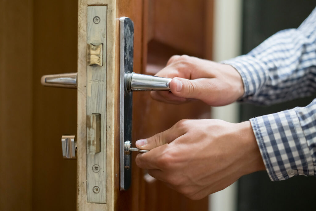 Locksmith unlocking residential door lock professionally
