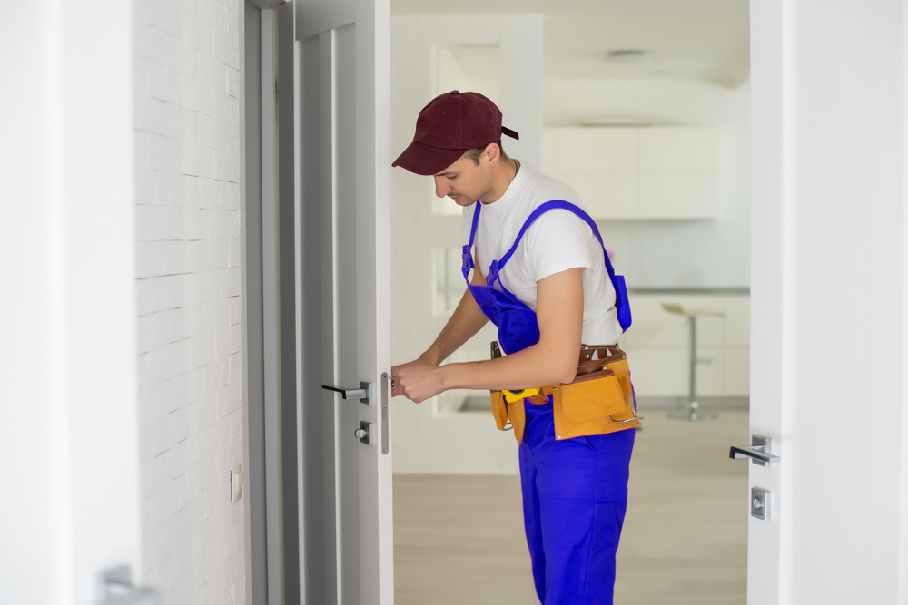 Locksmith installing modern interior door