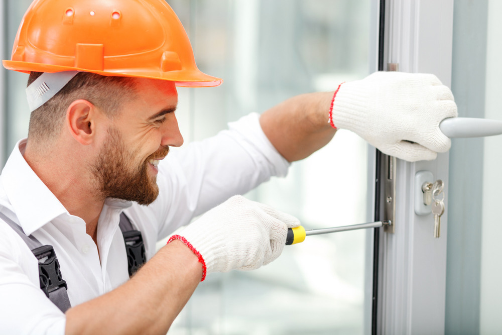 Locksmith installing door handle on seasonal property