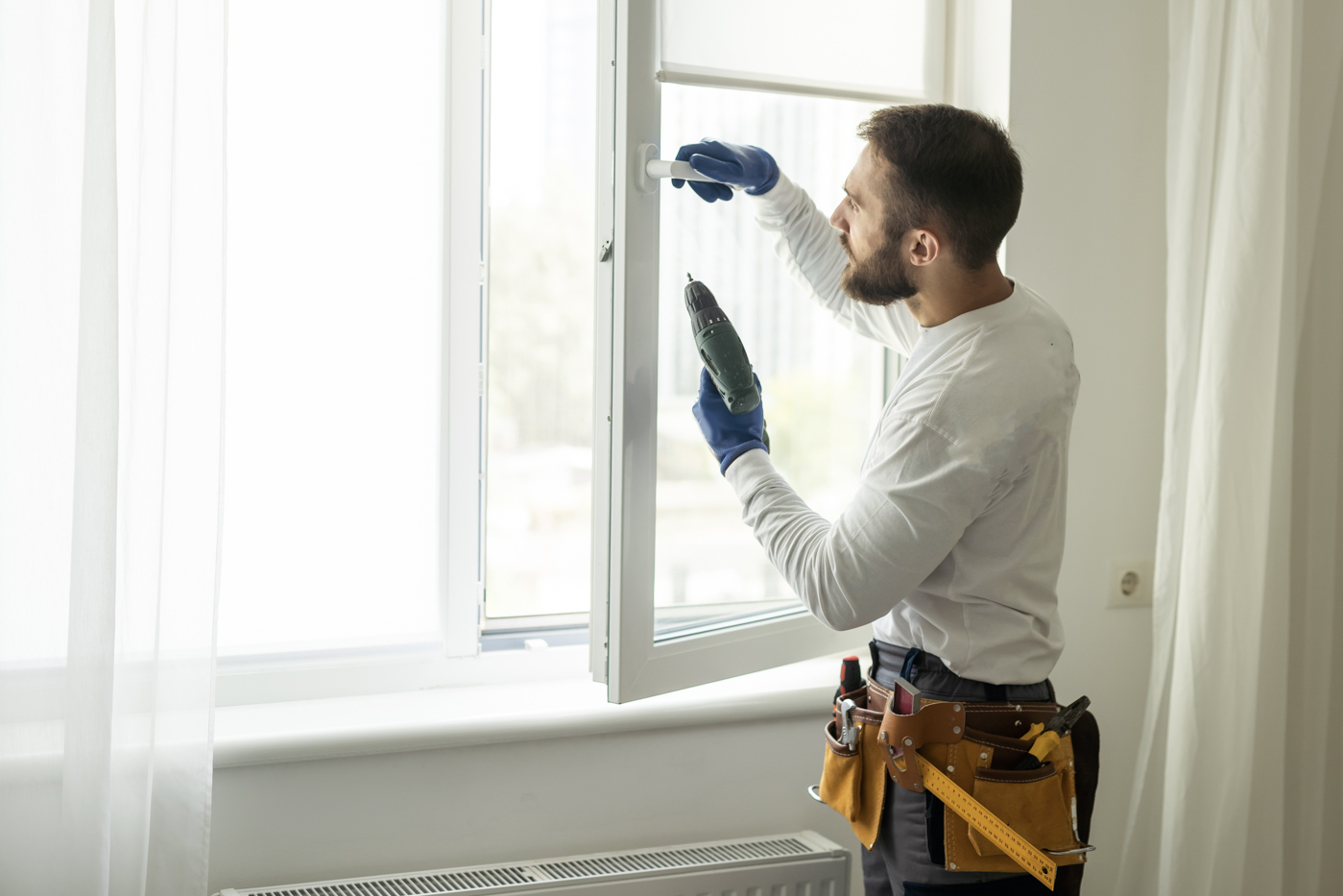 Technician installing window latch