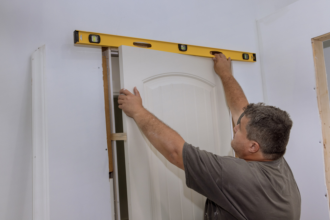 Worker handling window panels in factory