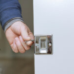 Locksmith installing door lock