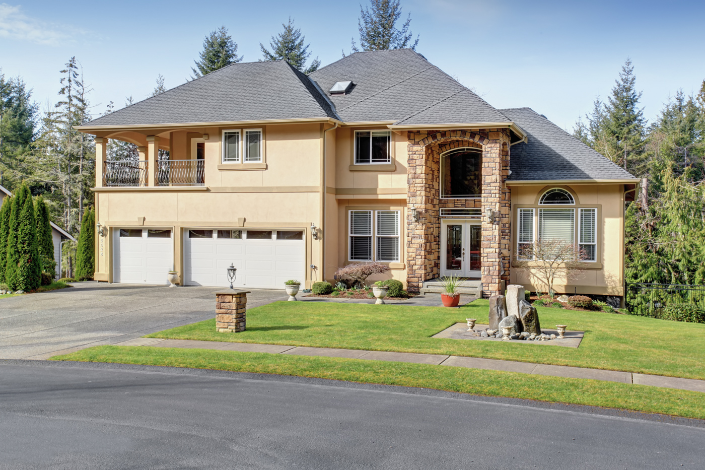 Residential home with triple garage doors