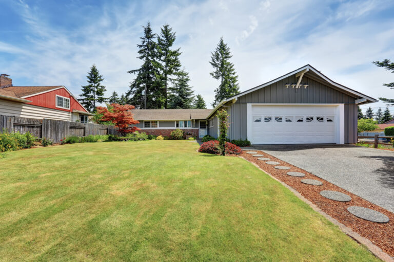 Contemporary Ontario home with double garage doors and manicured front yard