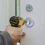 Technician installing commercial lock
