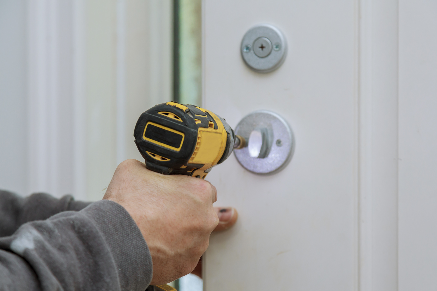 Technician installing commercial lock