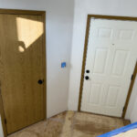 White door installation in Canadian basement