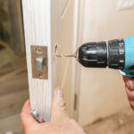 Locksmith drilling industrial door lock hole