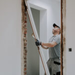 Worker installing large picture window