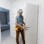 Door service technician repairing interior door