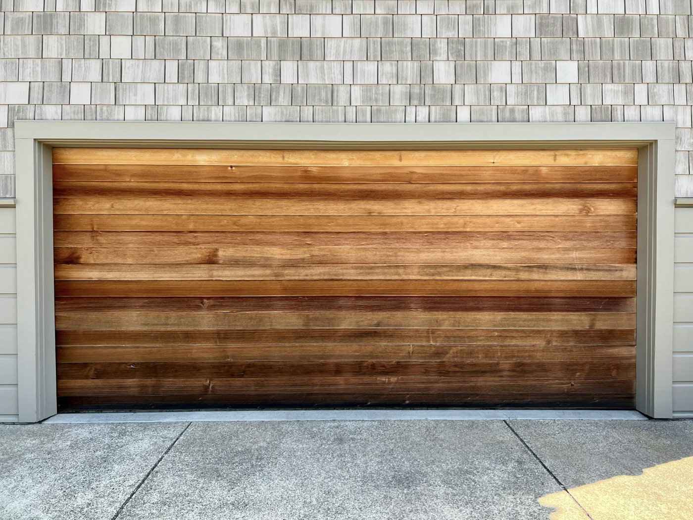 Modern wood garage door on Canadian home driveway