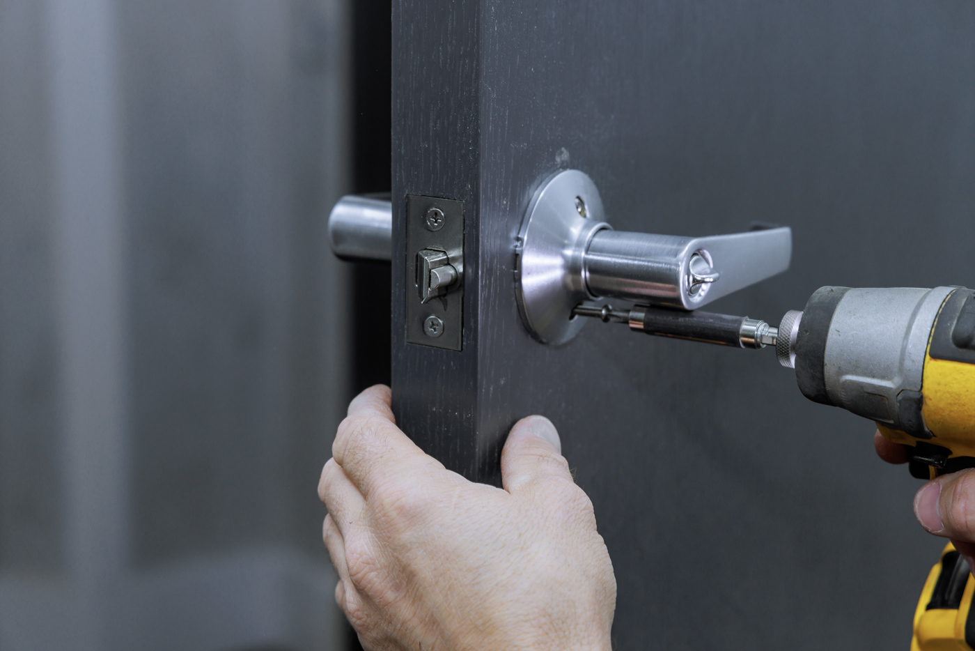 Locksmith installing lever lock on office door
