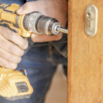 Healthcare locksmith installing hospital lock