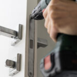 Locksmith installing monitored door lock