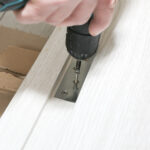 Door hinge installation on white door