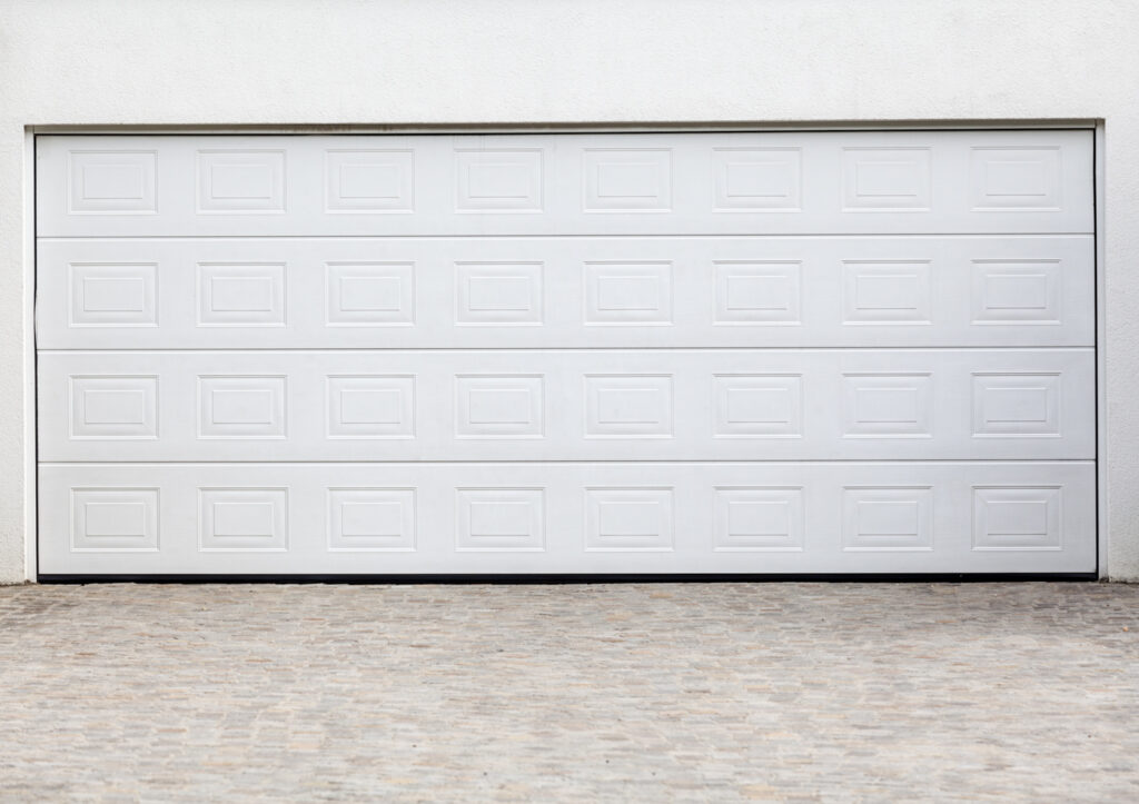 White residential garage door panel repair