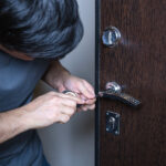 Locksmith repairing door lock for patio security