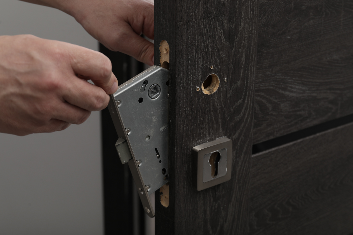 Locksmith installing patio door lock